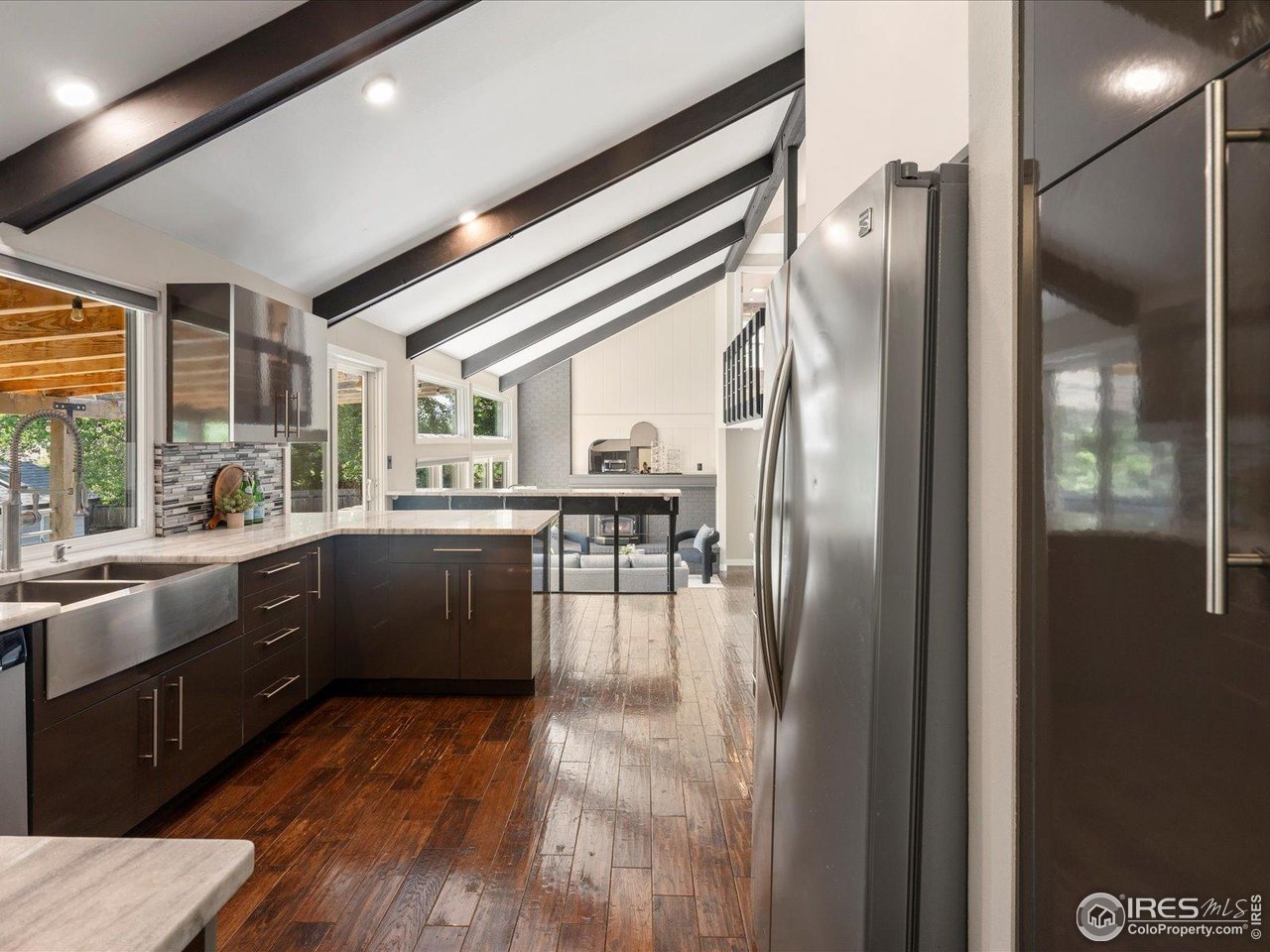 7466 Old Post Road Boulder, CO 80301 - Photo 12 of 36 a kitchen with stainless steel appliances granite countertop a refrigerator a sink dishwasher a stove and a dining table with wooden floor