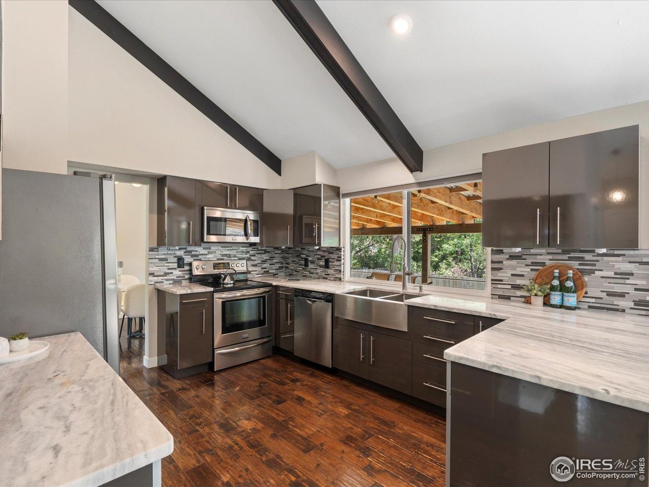 7466 Old Post Road Boulder, CO 80301 - Photo 14 of 36 a kitchen with stainless steel appliances granite countertop a stove and a sink