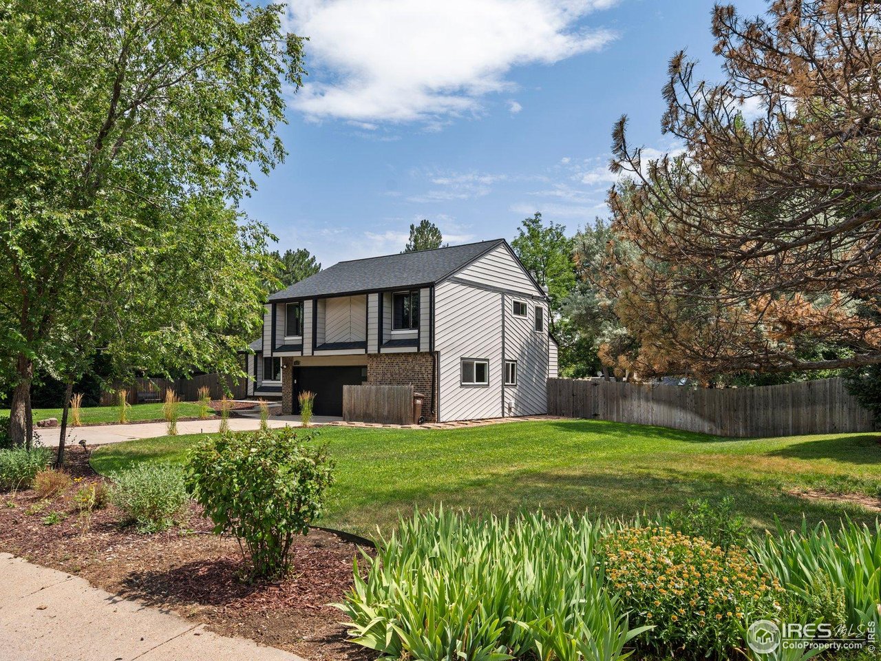 7466 Old Post Road Boulder, CO 80301 - Photo 2 of 36 a view of a house with a big yard and potted plants