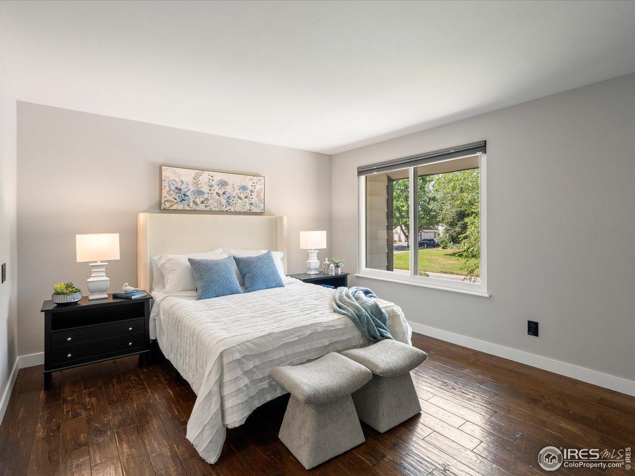 7466 Old Post Road Boulder, CO 80301 - Photo 22 of 36 a bedroom with a bed and wooden floor