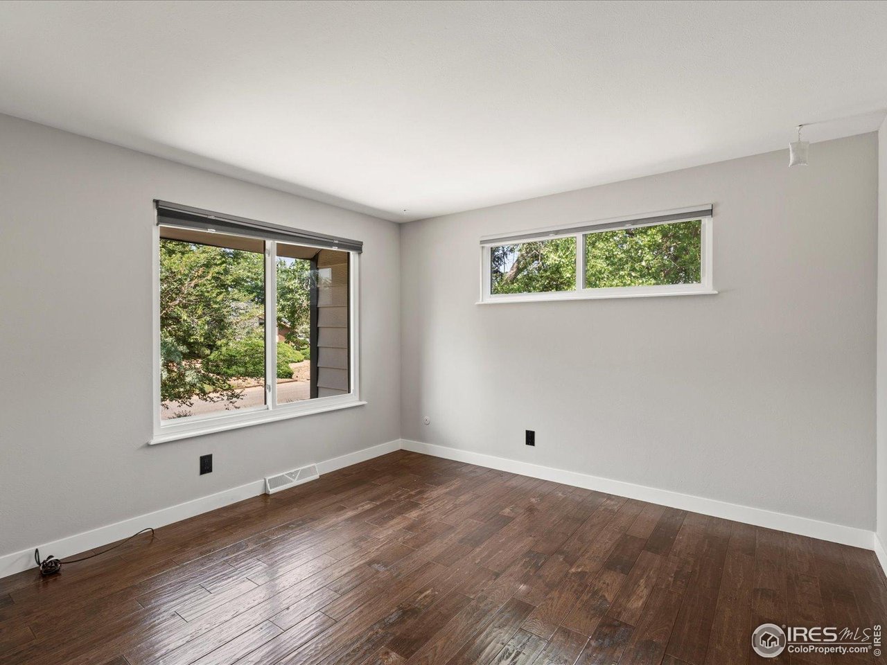 7466 Old Post Road Boulder, CO 80301 - Photo 26 of 36 a view of an empty room with wooden floor and a window