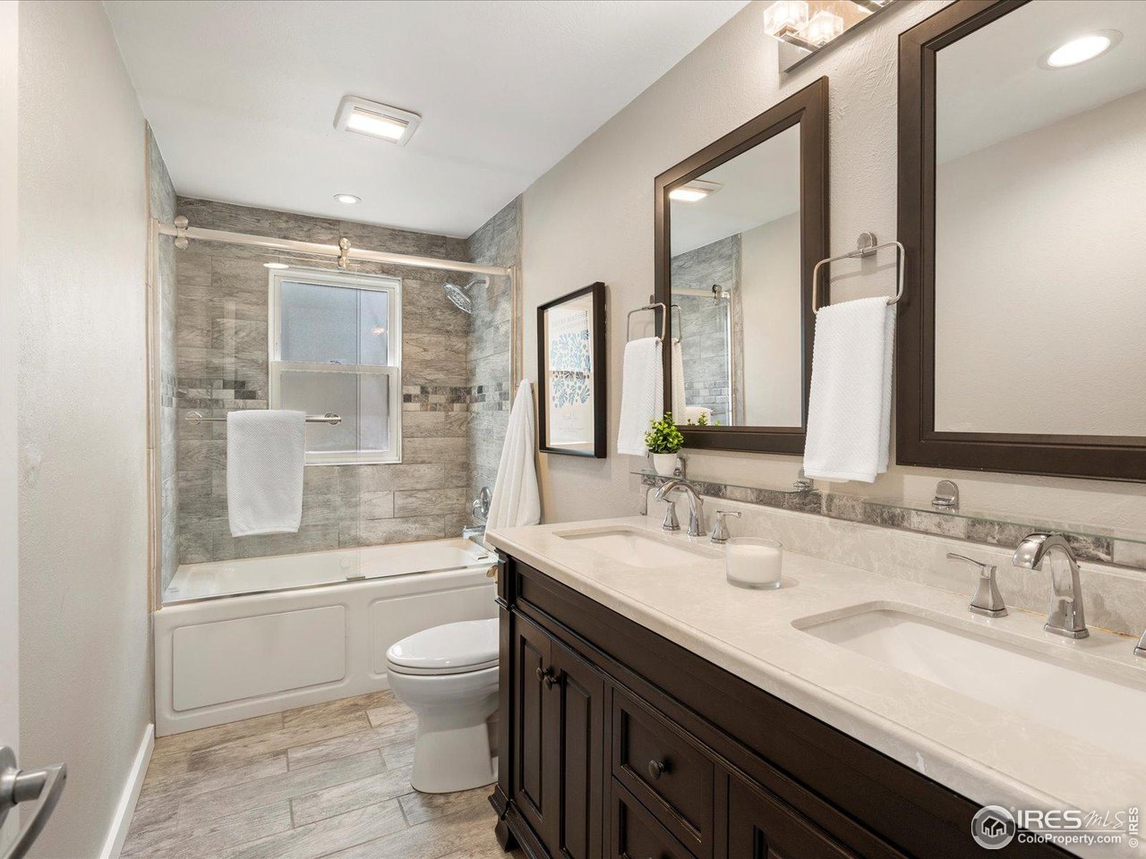 7466 Old Post Road Boulder, CO 80301 - Photo 28 of 36 a bathroom with a double vanity sink toilet mirror and bathtub