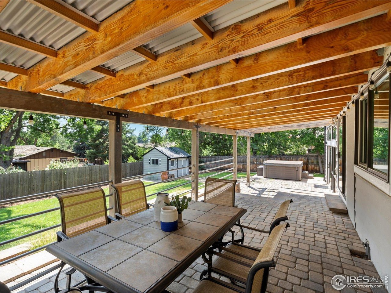 7466 Old Post Road Boulder, CO 80301 - Photo 30 of 36 a view of a patio with a dining table and chairs with wooden floor