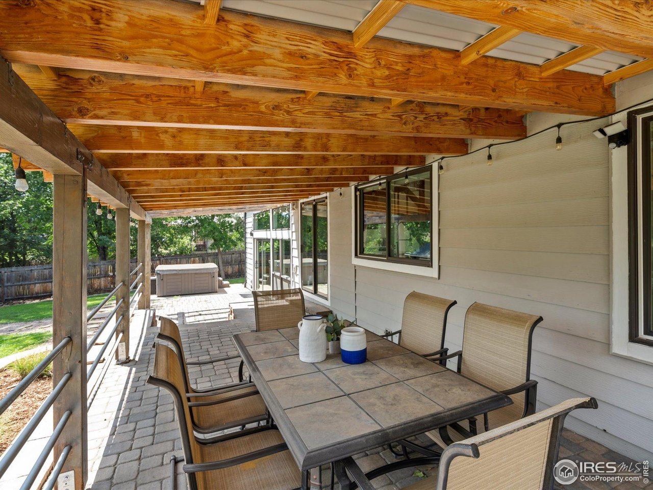 7466 Old Post Road Boulder, CO 80301 - Photo 31 of 36 a view of a patio with couches and table and chairs next to a yard