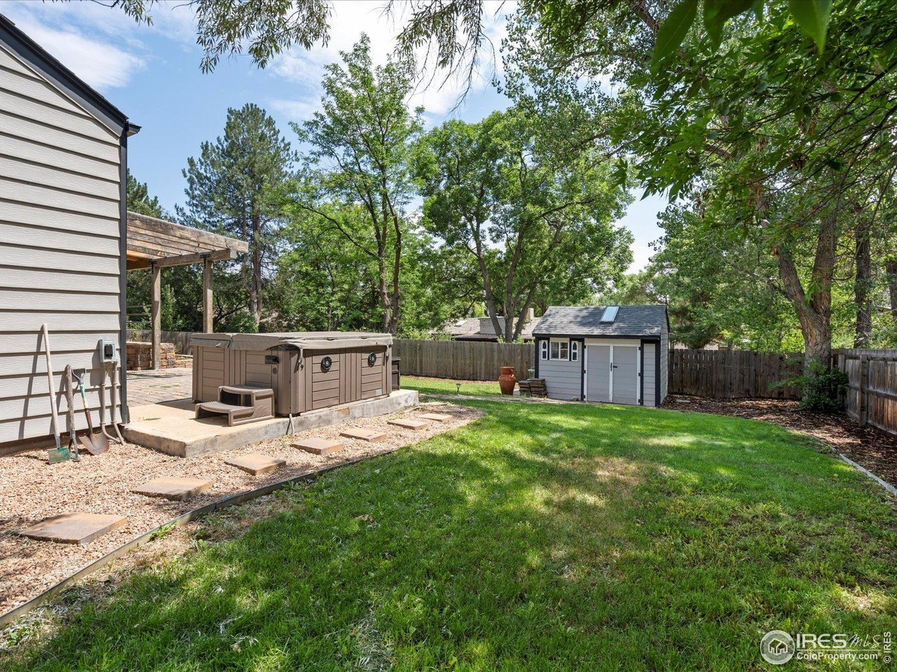 7466 Old Post Road Boulder, CO 80301 - Photo 32 of 36 a view of a backyard with table and chairs and a large tree