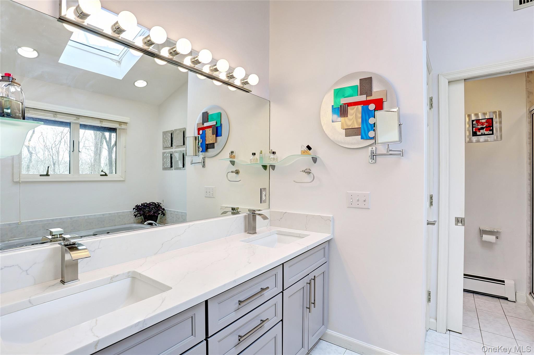 42 Cragmere Road Airmont, NY 10901 - Photo 14 of 32 a bathroom with a sink a mirror and a shower