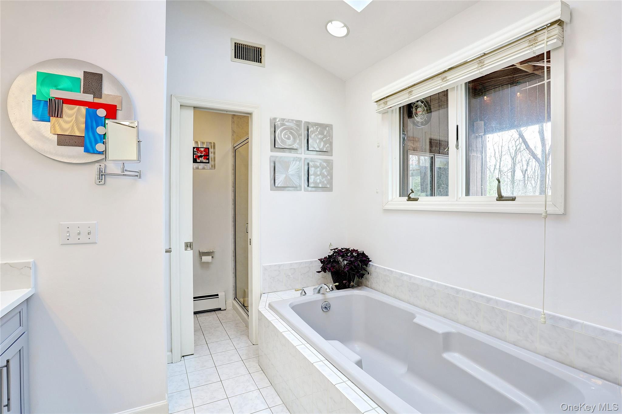 42 Cragmere Road Airmont, NY 10901 - Photo 15 of 32 a bathroom with a tub a sink and a shower