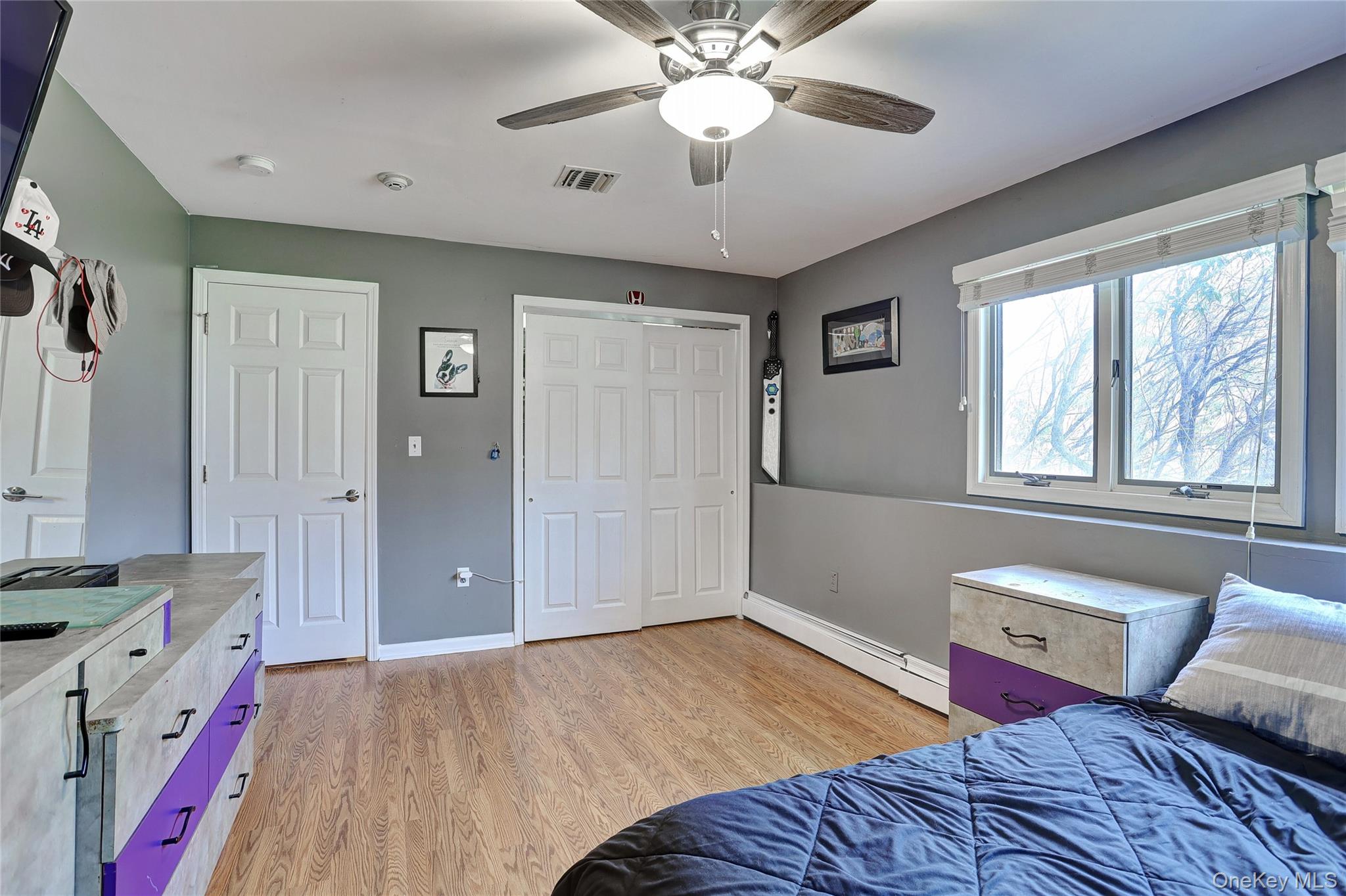 42 Cragmere Road Airmont, NY 10901 - Photo 23 of 32 a bedroom with a bed and a chandelier