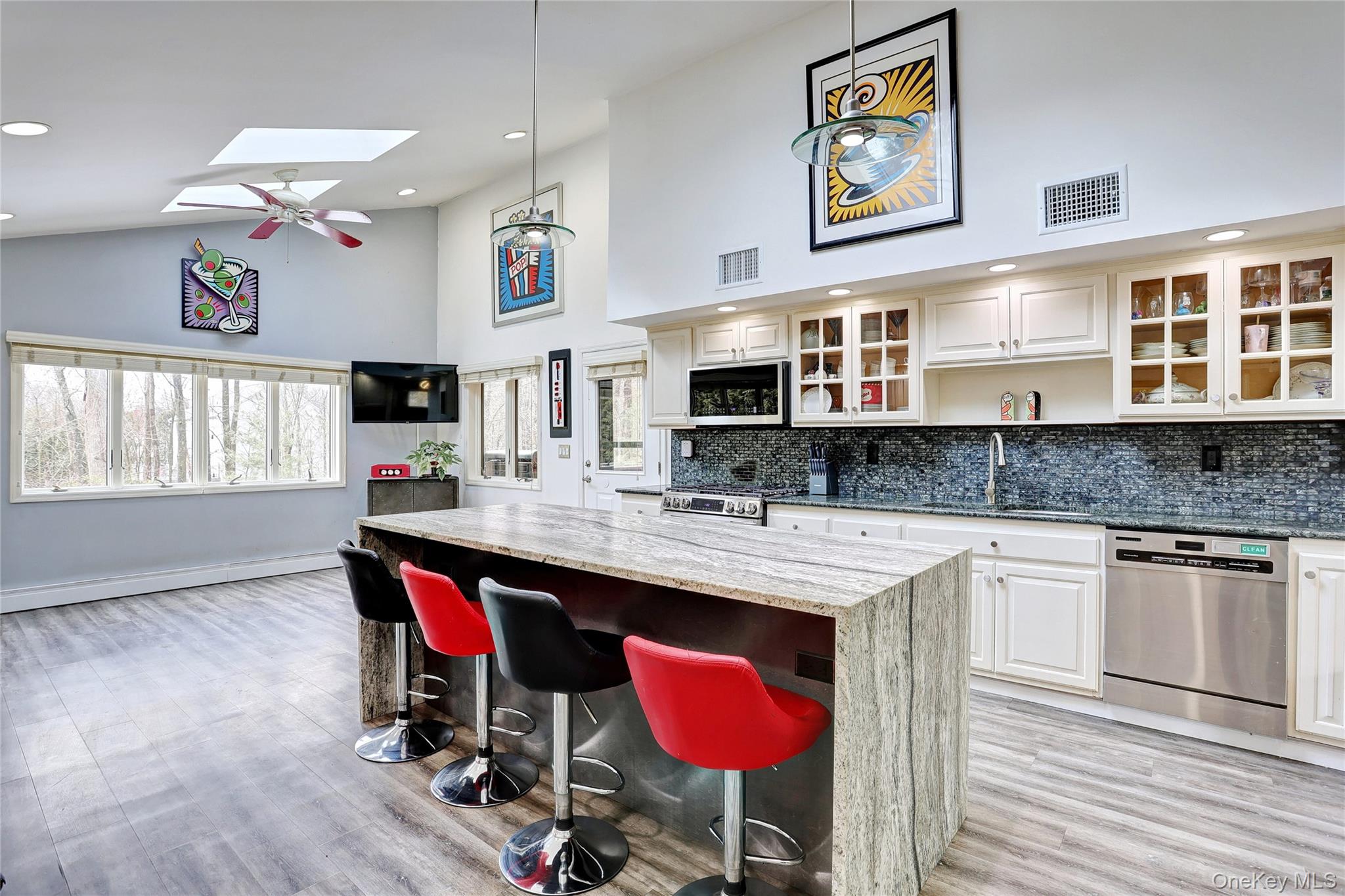 42 Cragmere Road Airmont, NY 10901 - Photo 9 of 32 a kitchen with stainless steel appliances granite countertop a kitchen island hardwood floor sink stove dining table and chairs