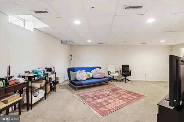 a living room with lots of furniture and a flat screen tv