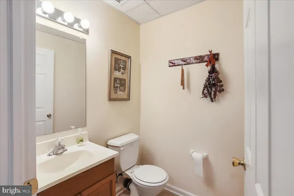a bathroom with a sink mirror and toilet