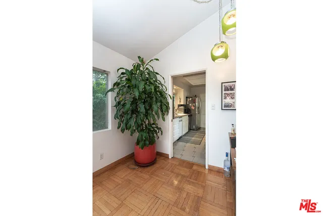 a view of a hallway with potted plants