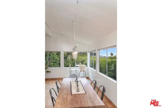 a living room with furniture and large windows