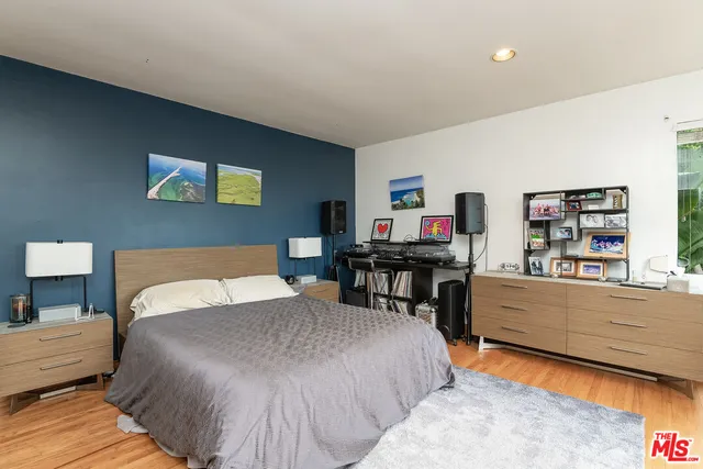 a bedroom with a bed and a bookshelf