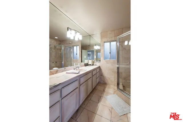 a large bathroom with a double vanity sink and mirror