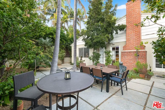 a view of a patio with a table and chairs