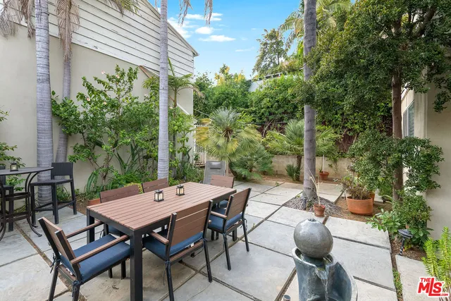 a view of a wooden table and chairs in patio