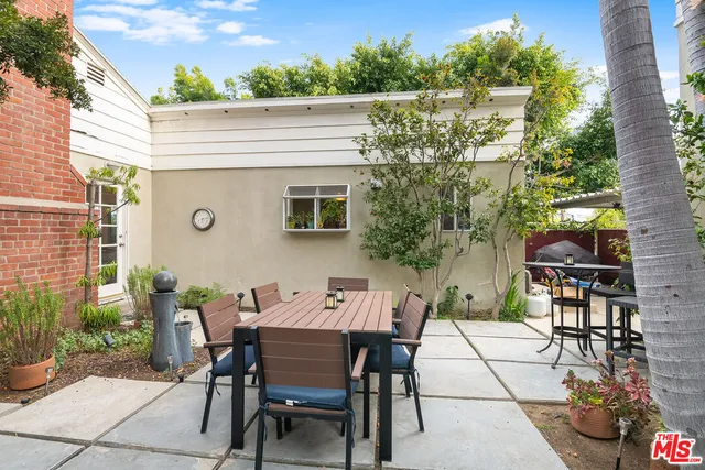 a view of a patio with table and chairs and potted plants