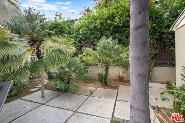 a view of backyard with outdoor space and trees