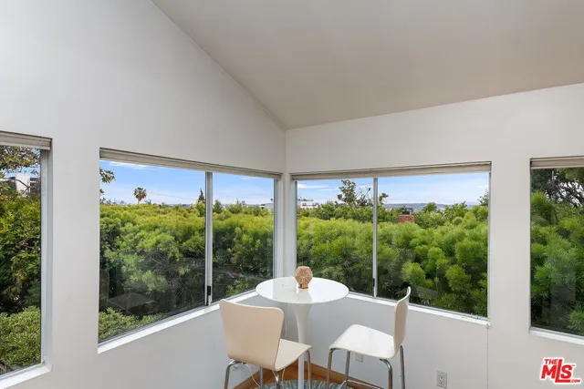 a view of a room with balcony and furniture