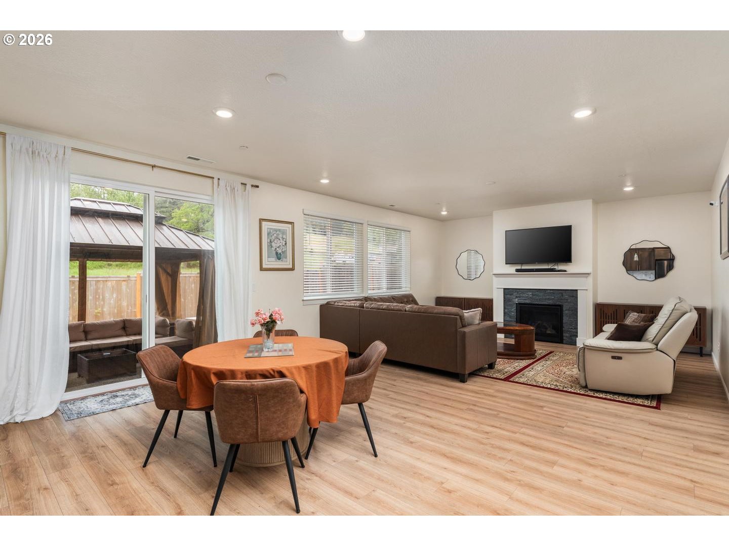 6301 North 89th Avenue Camas, WA 98607 - Photo 5 of 39 a living room with furniture a fireplace and a flat screen tv