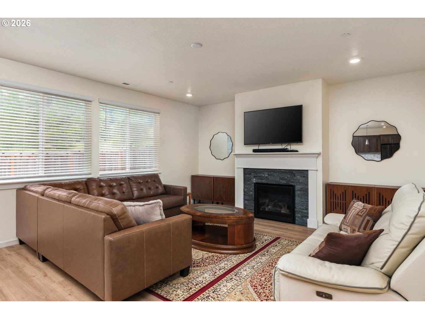6301 North 89th Avenue Camas, WA 98607 - Photo 6 of 39 a living room with furniture a flat screen tv and a fireplace
