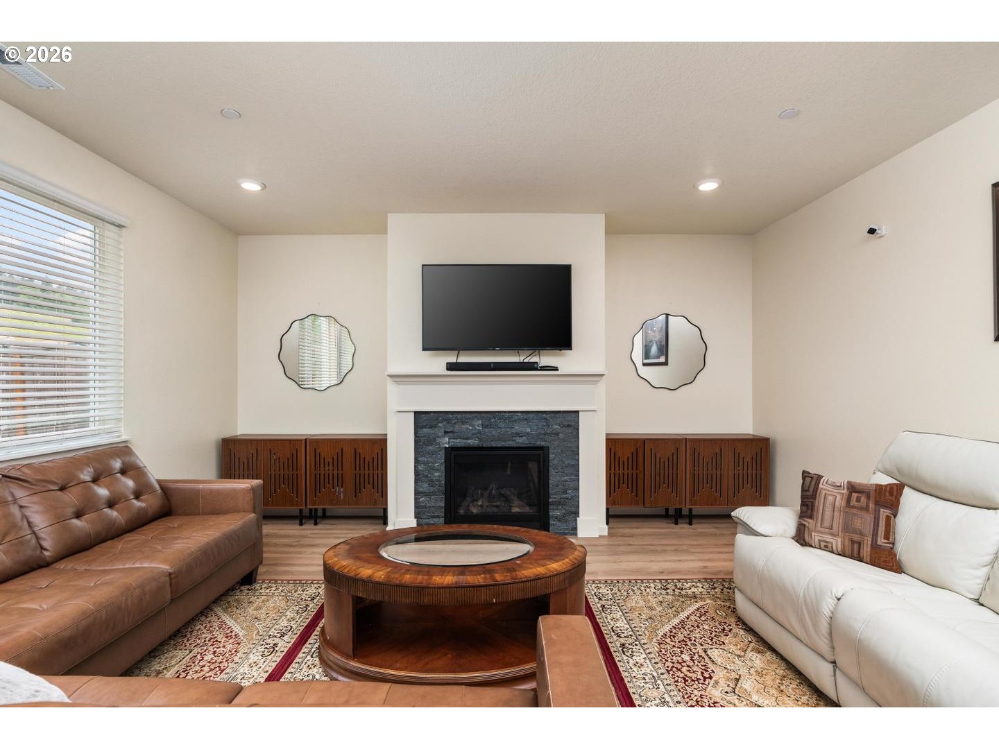 6301 North 89th Avenue Camas, WA 98607 - Photo 7 of 39 a living room with furniture a fireplace and a flat screen tv