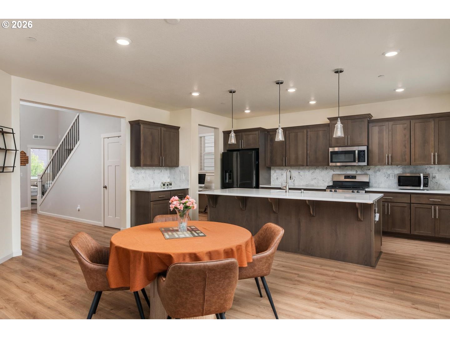 6301 North 89th Avenue Camas, WA 98607 - Photo 10 of 39 a kitchen with stainless steel appliances kitchen island granite countertop a table chairs sink and cabinets