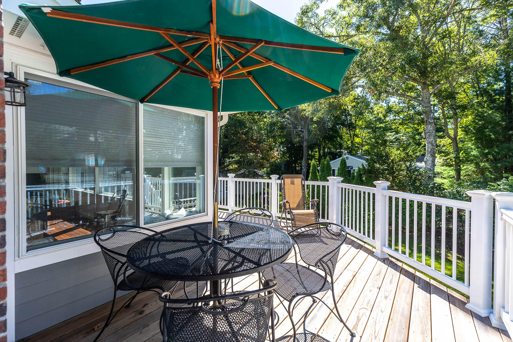 8 Cutlass Lane Mashpee, MA 02649 - Photo 15 of 30 a view of balcony with furniture and umbrella