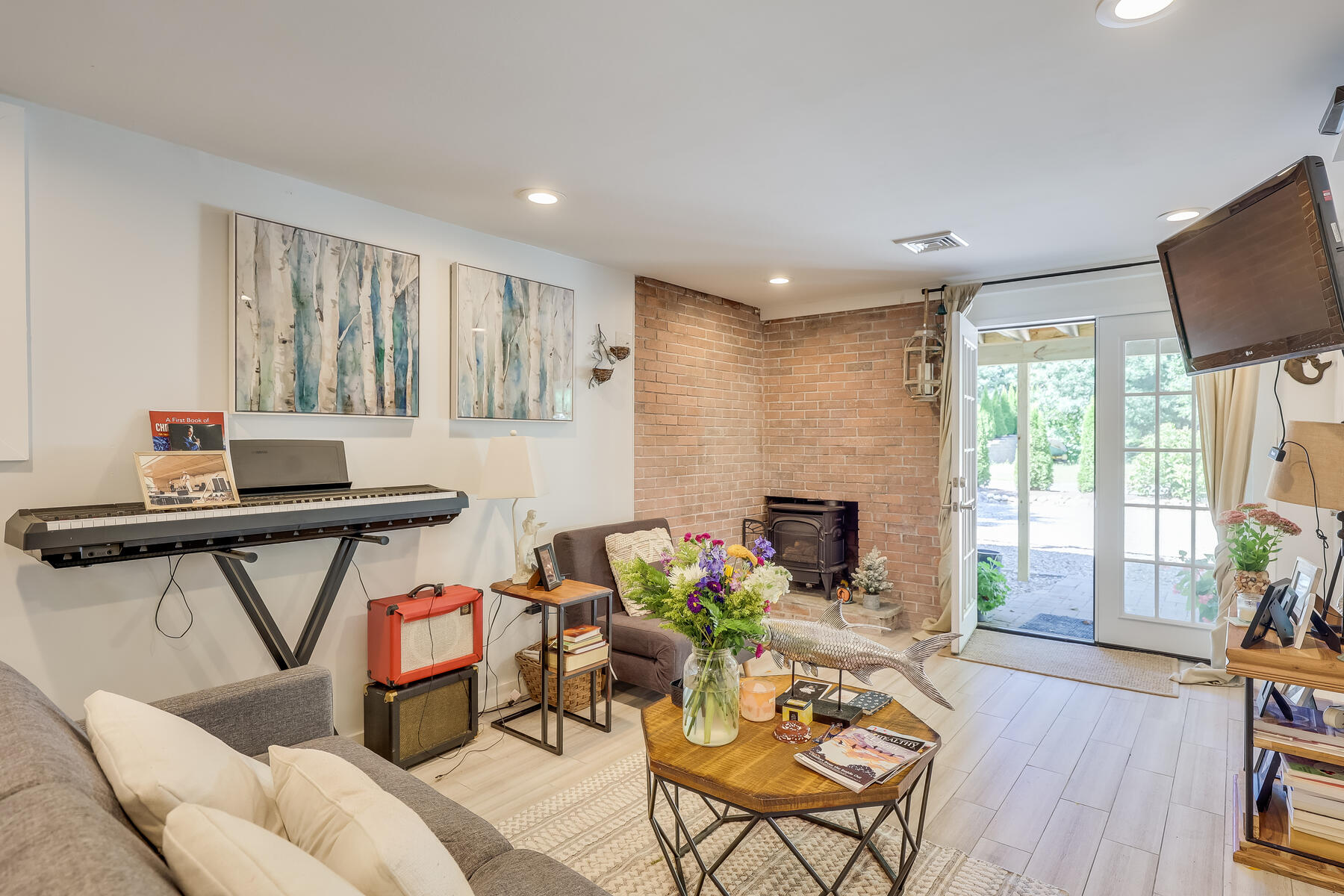 8 Cutlass Lane Mashpee, MA 02649 - Photo 18 of 30 a living room with furniture a fireplace and a floor to ceiling window