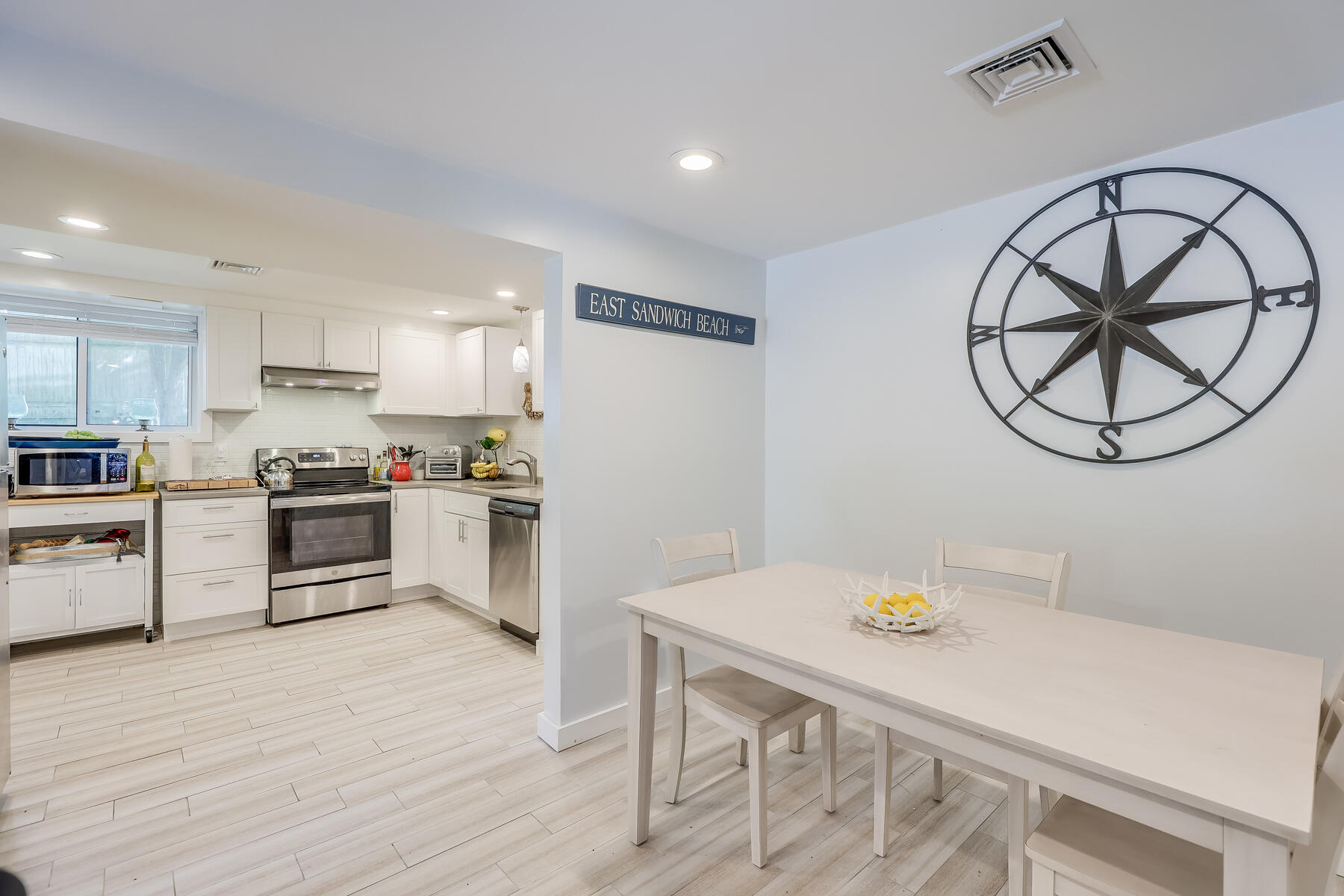 8 Cutlass Lane Mashpee, MA 02649 - Photo 19 of 30 a kitchen with a table and white stainless steel appliances