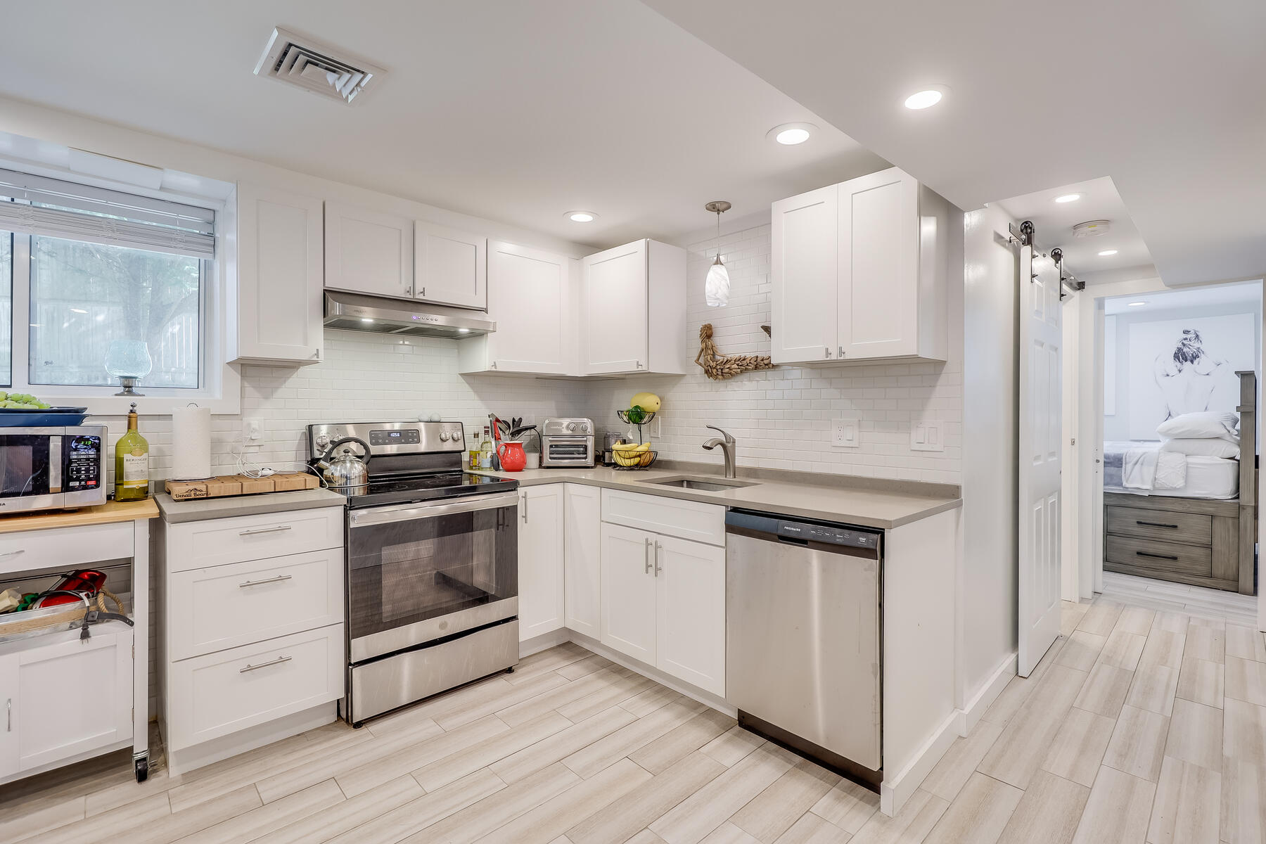 8 Cutlass Lane Mashpee, MA 02649 - Photo 21 of 30 a kitchen with stainless steel appliances granite countertop a stove a sink and white cabinets
