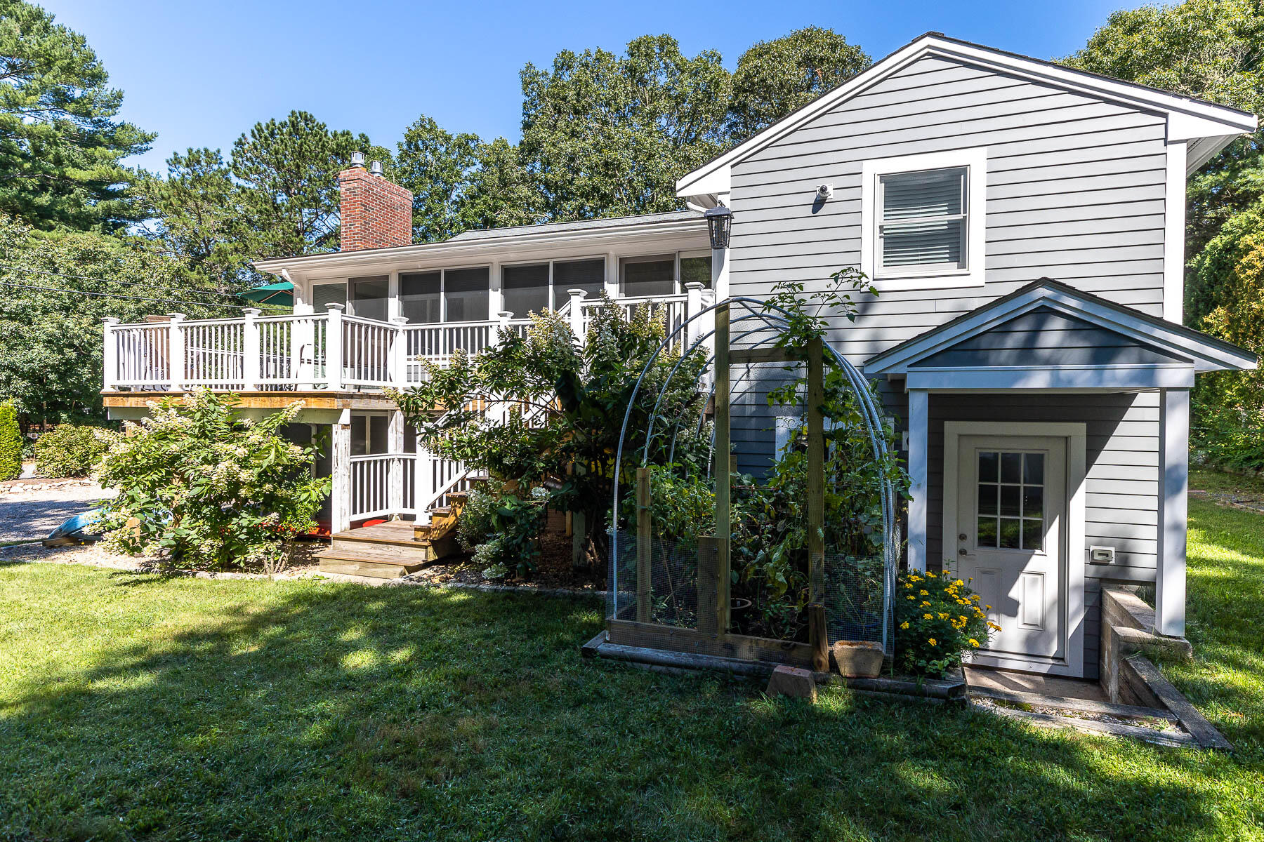 8 Cutlass Lane Mashpee, MA 02649 - Photo 24 of 30 a front view of a house with a yard and potted plants