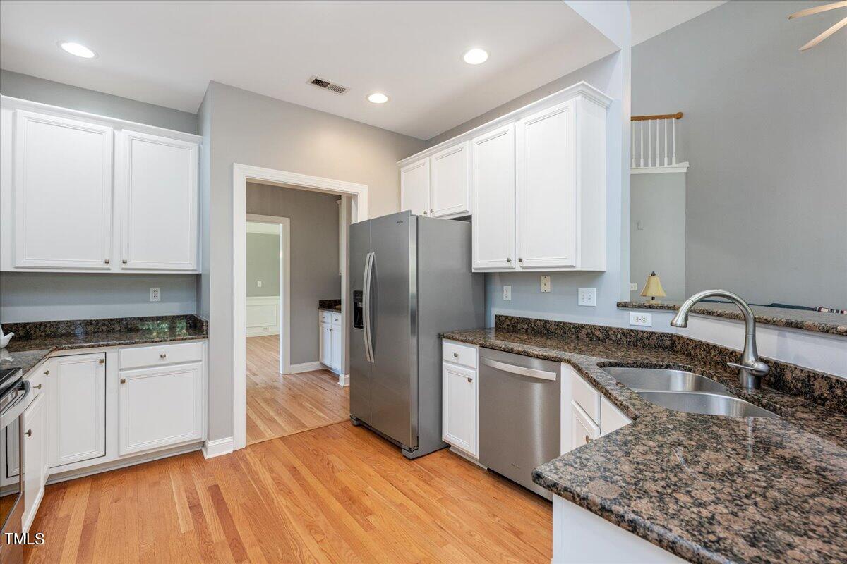 714 Continental Drive Durham, NC 27712 - Photo 12 of 34 a kitchen with granite countertop a sink stove and refrigerator