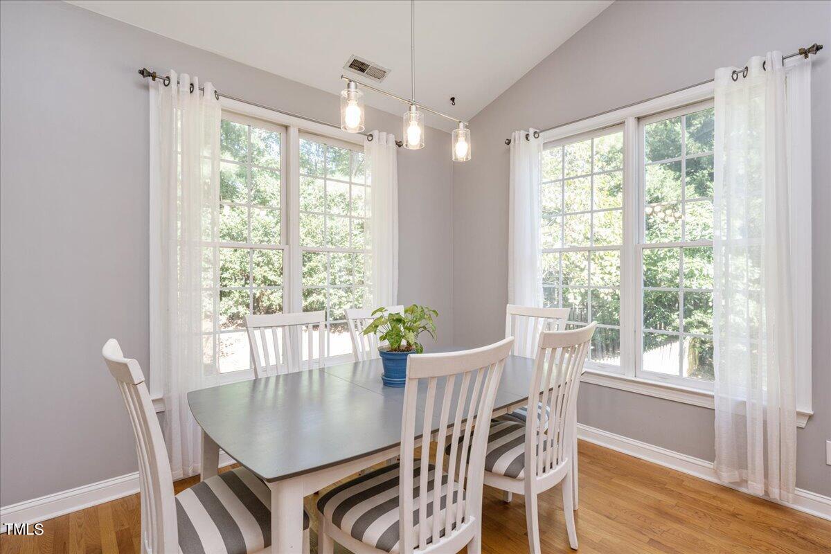 714 Continental Drive Durham, NC 27712 - Photo 14 of 34 a view of a dining room with furniture window and wooden floor