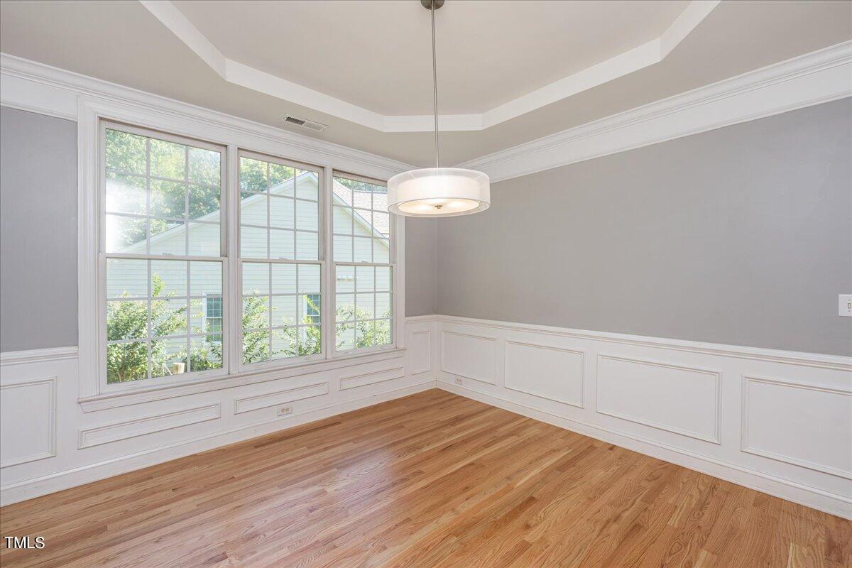 714 Continental Drive Durham, NC 27712 - Photo 16 of 34 a view of an empty room with wooden floor and a window
