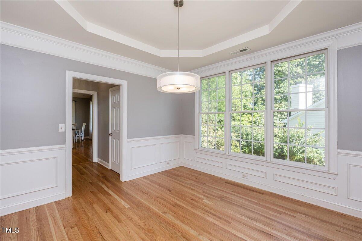 714 Continental Drive Durham, NC 27712 - Photo 17 of 34 a view of an empty room with wooden floor and a window