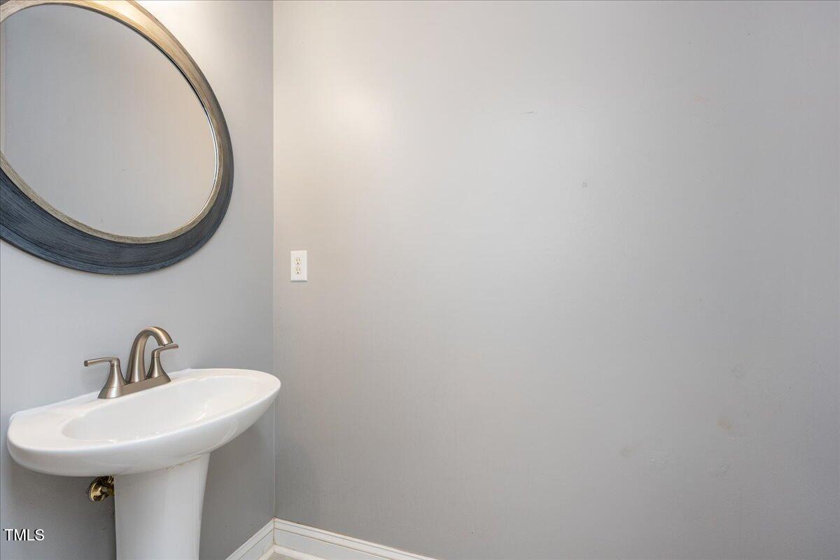 714 Continental Drive Durham, NC 27712 - Photo 18 of 34 a bathroom with a sink and a mirror