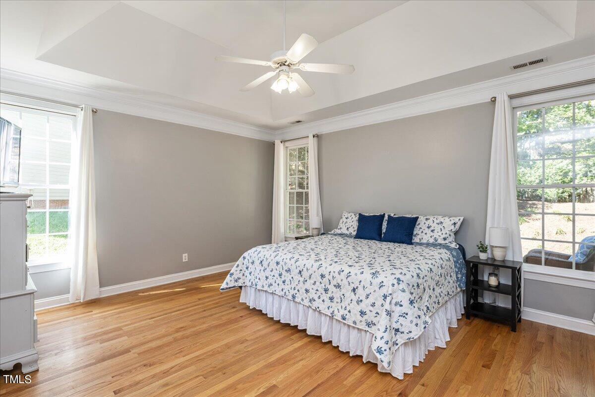 714 Continental Drive Durham, NC 27712 - Photo 19 of 34 a bedroom with a large bed chandelier and a window