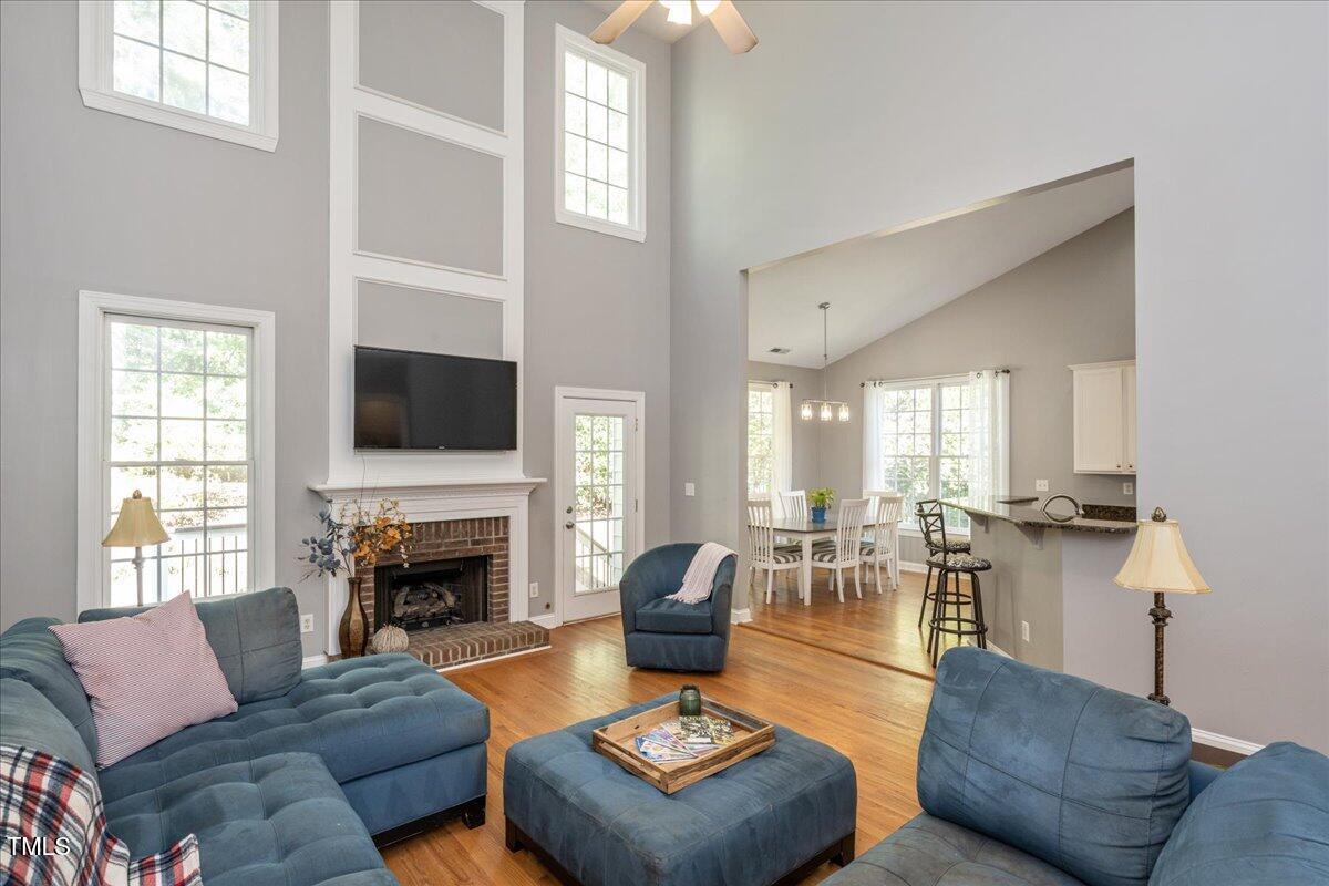 714 Continental Drive Durham, NC 27712 - Photo 2 of 34 a living room with furniture a fireplace a flat screen tv and windows