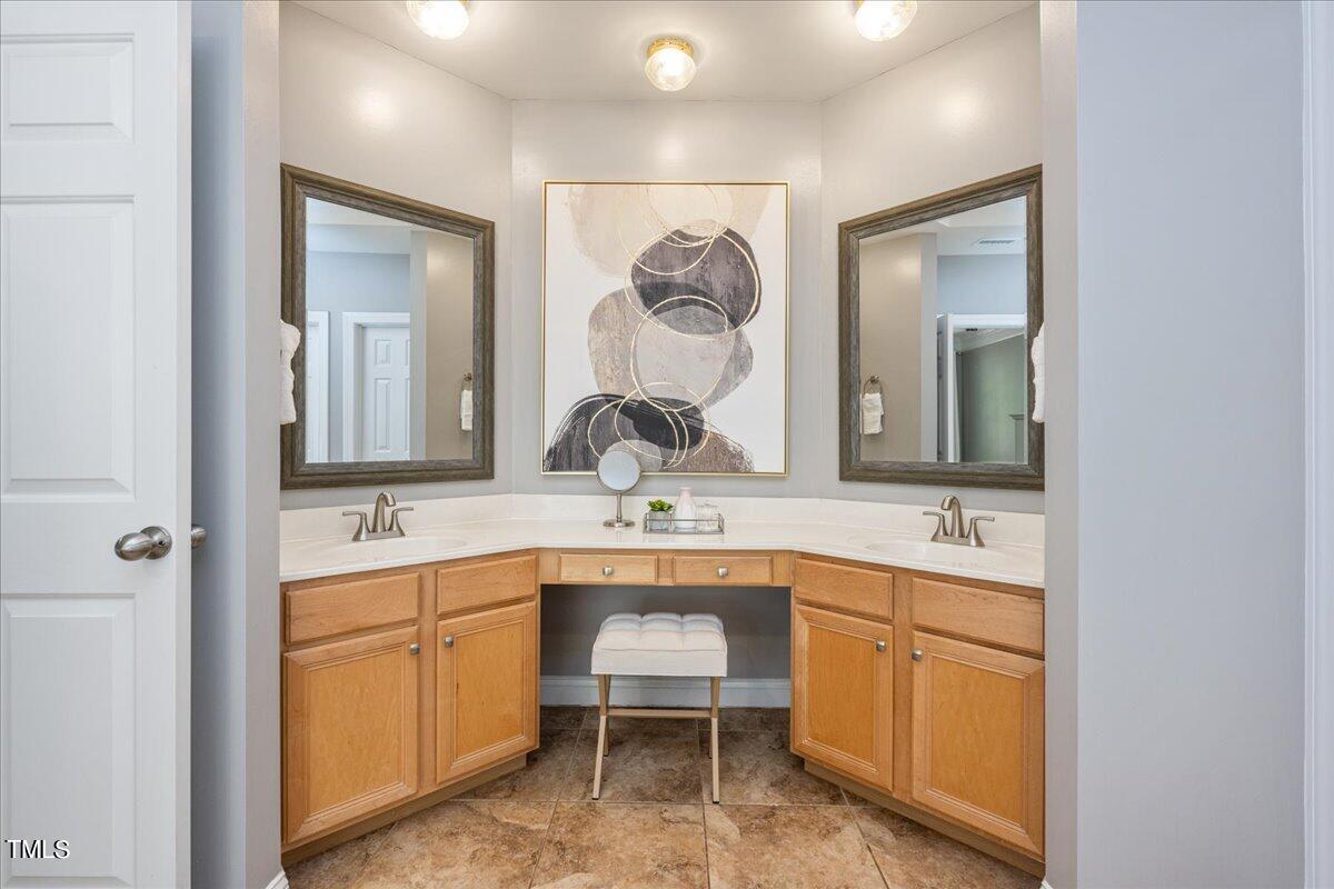 714 Continental Drive Durham, NC 27712 - Photo 21 of 34 a bathroom with a double vanity sink and a mirror