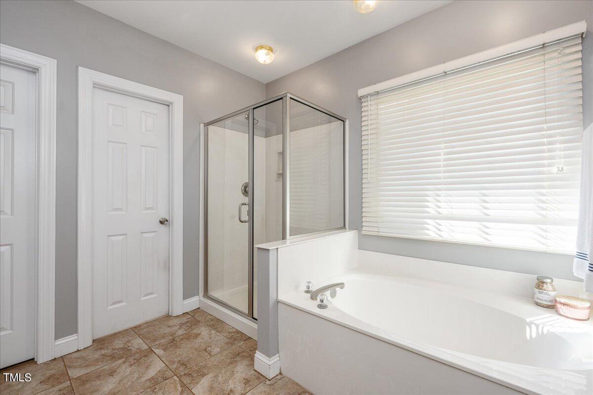 714 Continental Drive Durham, NC 27712 - Photo 22 of 34 a bathroom with a bathtub and a shower