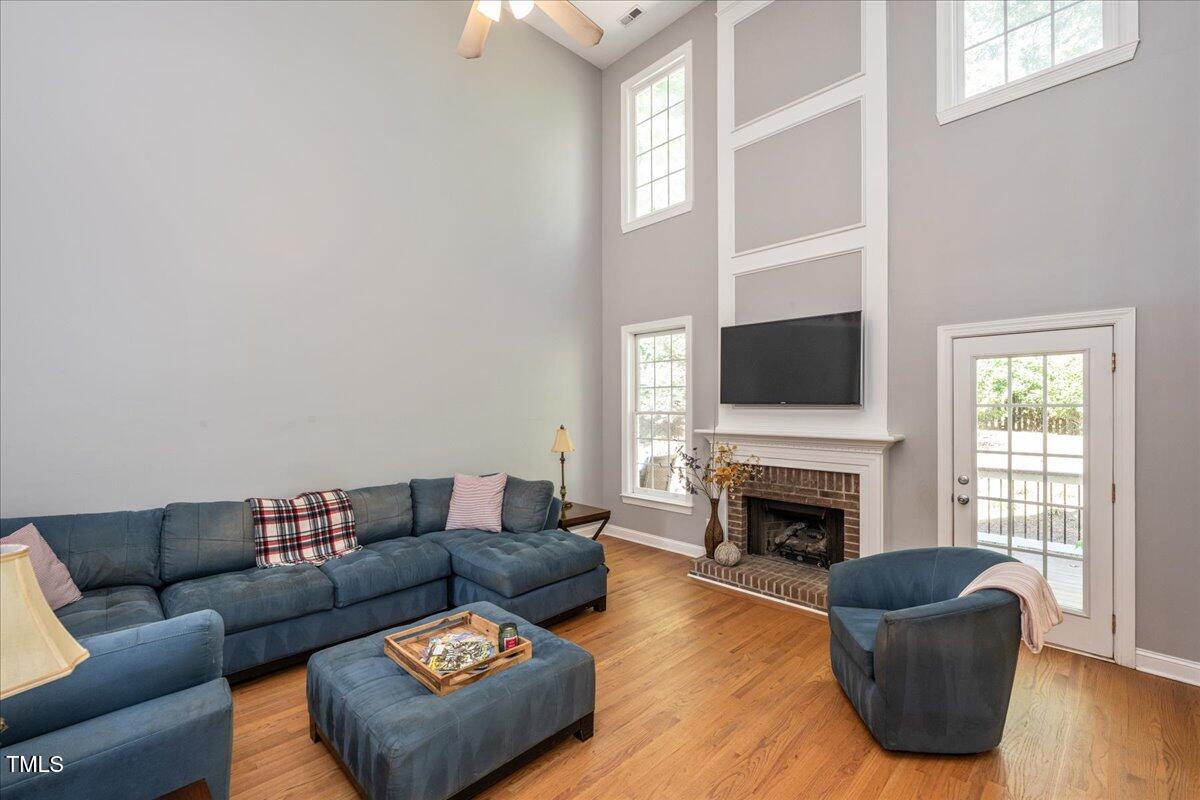 714 Continental Drive Durham, NC 27712 - Photo 8 of 34 a living room with furniture flat screen tv and a fireplace