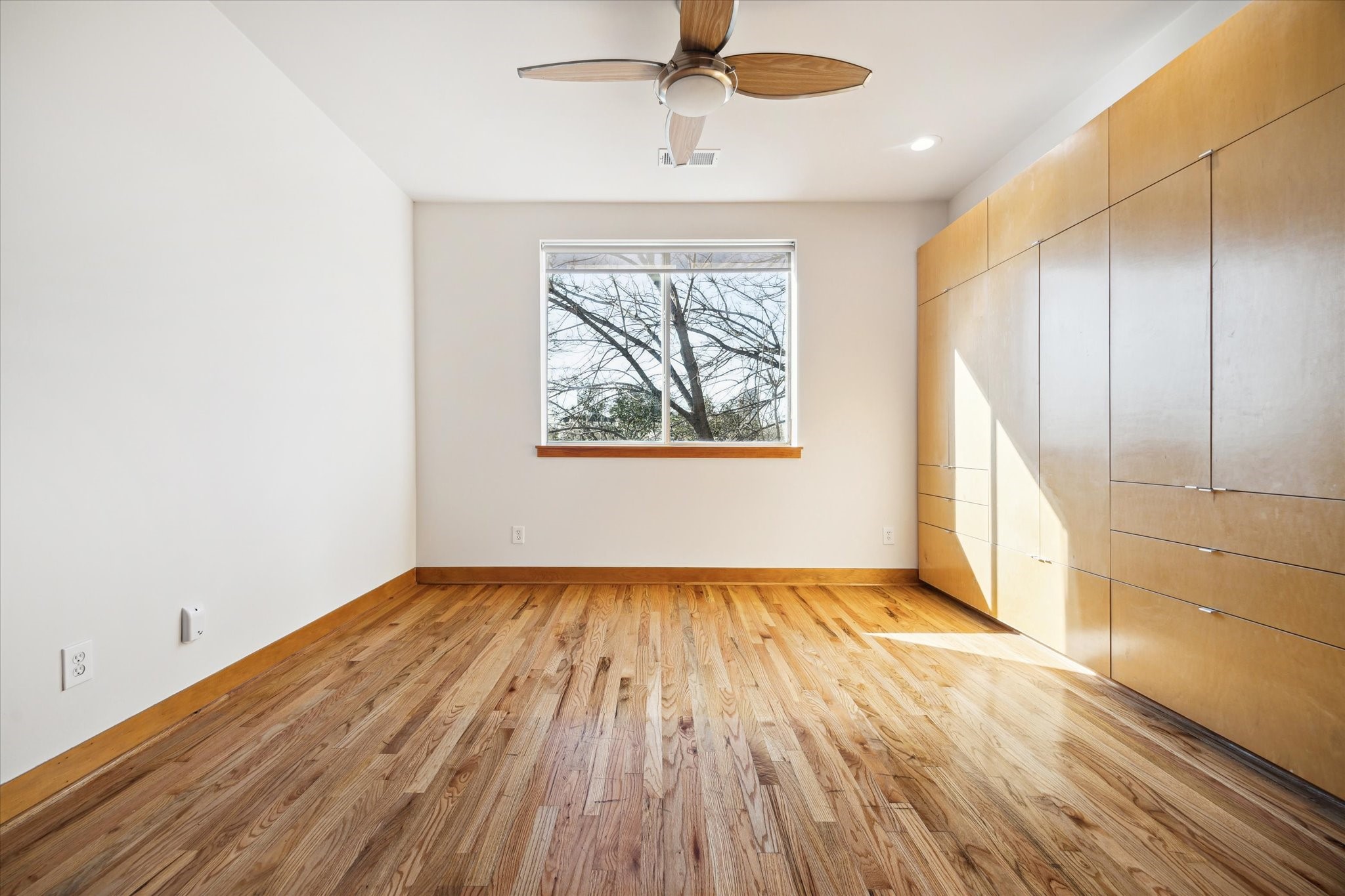 94 Drew Street, Unit C Houston, TX 77006 - Photo 21 of 29 Light-filled loft with a wall of storage, offering endless possibilities as a home office, media room, fitness studio, guest retreat, or creative workspace.