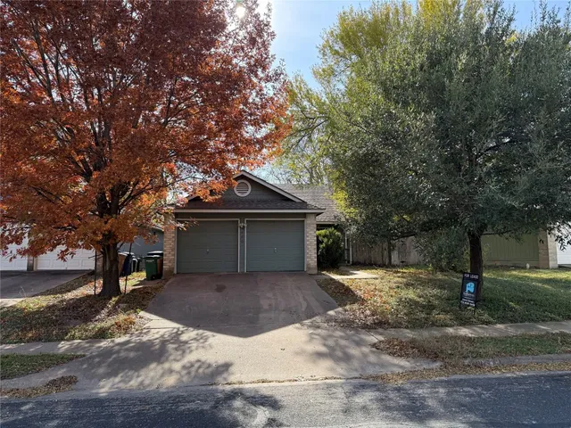 a house that has a tree in front of it