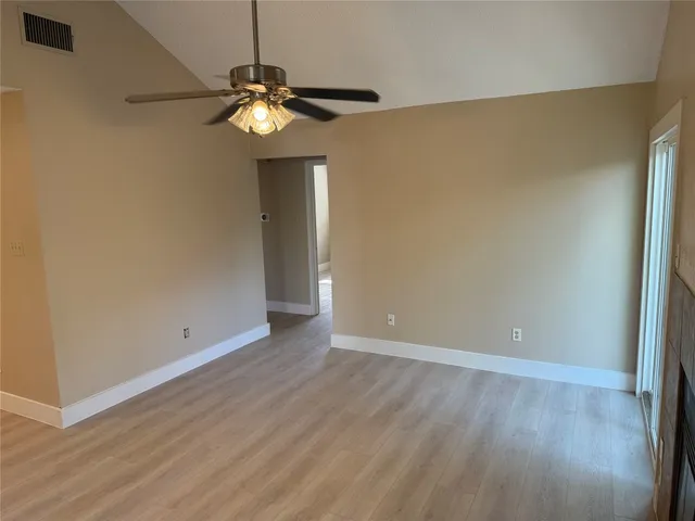 a view of wooden floor and chandelier in a room