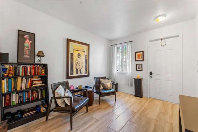 a living room with furniture and a book shelf