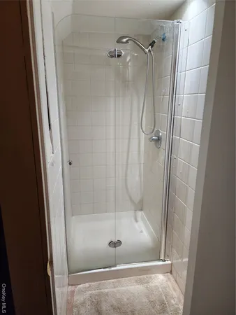 a bathroom with a glass door shower