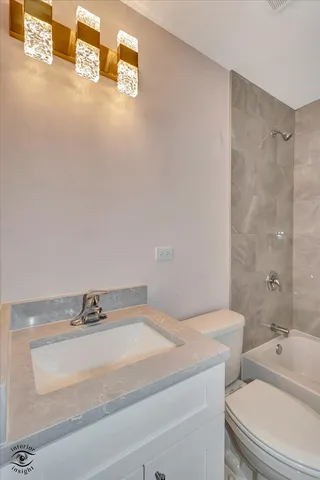 a bathroom with a sink and mirror with toilet