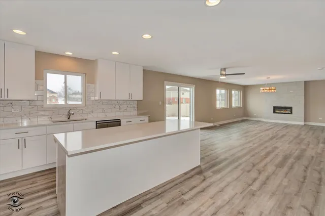 a large kitchen with stainless steel appliances granite countertop a lot of counter space and a sink